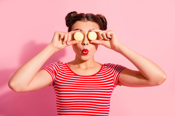 Poster - Close-up portrait of her she nice cute attractive glamorous funny cheerful cheery girl wearing striped t-shirt covering closing eyes with colorful snacks isolated over pink pastel background