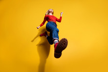 Low Below Angle Full Length Body Size View Of Nice Attractive Cheerful Girl Having Fun Going Making Step Wearing Vintage Retro Maroon Boots Isolated Over Bright Vivid Shine Orange Background