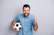 Close up photo macho he him his gentleman guy hold football leather ball watch match game true fan yelling loud amazed wear casual jeans denim shirts outfit clothes isolated light grey background