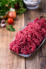 Wall Mural - Minced beef, raw ground meat with cooking ingredients