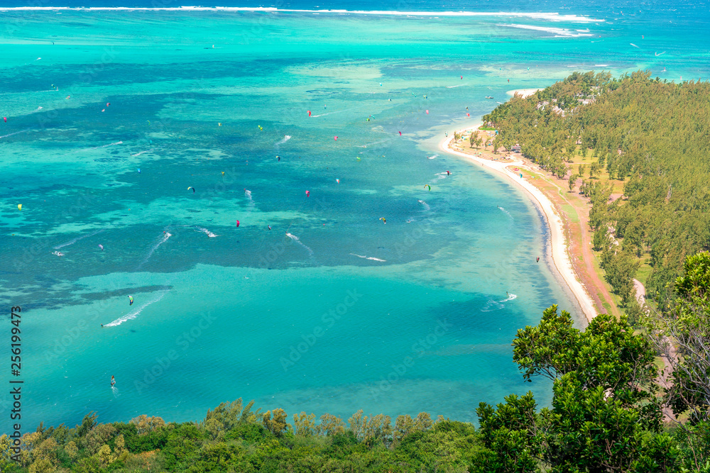 Beautiful view of a tropical beach with crystal clear water full of people windsurfing, from the mountain in le Le Morne Brabant, Mauritius - obrazy, fototapety, plakaty 