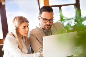 Colleagues discussing plans remember looking at laptop