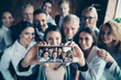 © deagreez - Close up blurry photo business people different age race free time excited team building hug embrace cuddle she her he him his telephone smart phone make take selfies  formal wear jackets shirts