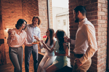 Wall Mural - Company of nice attractive pretty classy cheerful positive guys ladies having fun talk romantic atmosphere every year tradition buffet snack in fashionable industrial loft interior room indoors