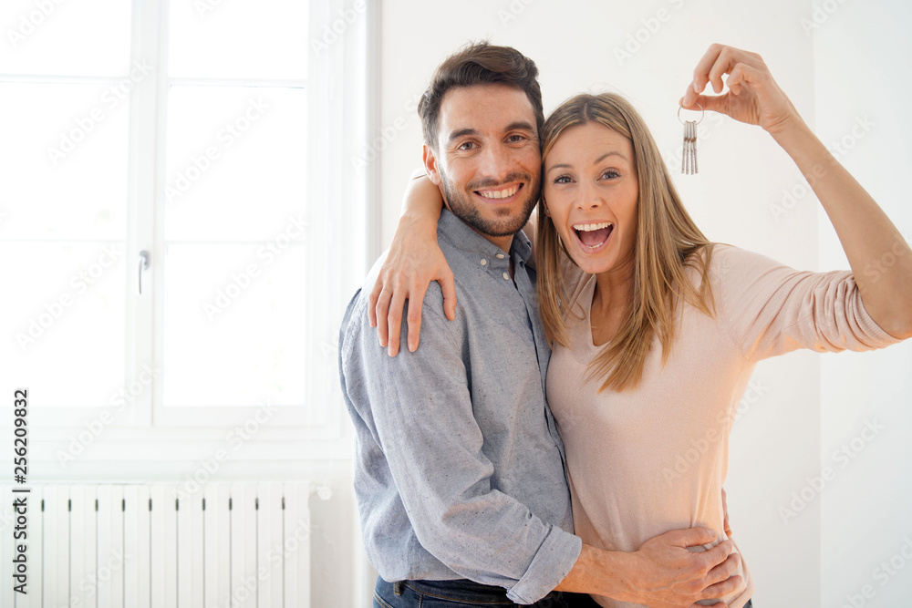 Happy couple with keys to new home - obrazy, fototapety, plakaty 