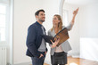 © goodluz - Real estate agent showing contemporary house for sale
