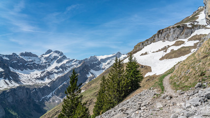 Switzerland, Beautiful scenic view on snow Alps peaks with blue sky and white clouds above