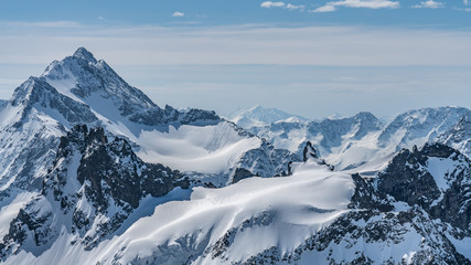  Switzerland, panorama view from Titlis mountain on Alps and mountains above white clouds