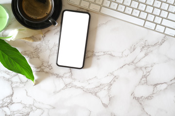 Mock up blank screen mobile phone on marble office desk