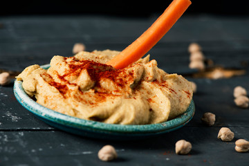 Poster - dipping carrot in a homemade hummus