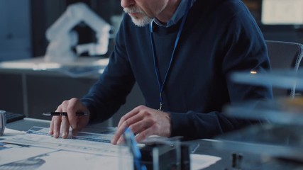 Poster - Professional Heavy Industry Engineer Draws Engine Concept Blueprint, References Computer. Engineering Bureau and Industrial Design Agency with Various Robotic, Architectural and Machinery Components