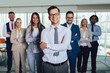 © Mediteraneo - Group of happy business people and company staff in modern office, representig company.Selective focus.