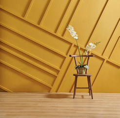 Yellow background wall with home object vase of flower computer and coffee table style.