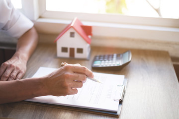 estate agent giving keys of new house to customer and explain house contract real estate concept