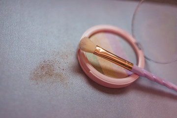 rainbow highlighter and cute twisted makeup brush close-up