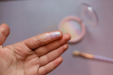 girl’s hand with rainbow highlighter test on finger