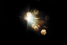 Lens Flare. Light Over Black Background. Easy To Add Overlay Or Screen Filter Over Photos. Abstract Sun Burst With Digital Lens Flare Background. Gleams Rounded And Hexagonal Shapes, Rainbow Halo.