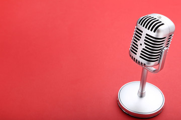 Vintage microphone on red background