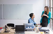 © Cavan Images - Business people discussing at desk in office