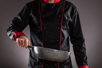 Closeup of chef holding empty frying pan