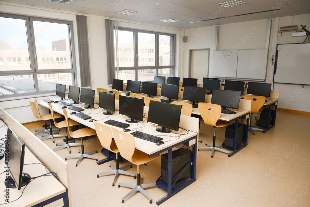 Computer classroom with monitors and keyboards for pupils and students ...