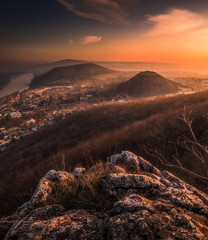 Wall Mural - View of a Small City near Danube River at Sunrise. Hainburg an der Donau, Austria as seen from Hundsheimer Hill with Rocky Foreground.