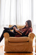 © Teodor Lazarev - Beautiful young woman reading a book at her home, relaxing and enjoying a nice quiet morning by herself