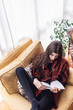 © Teodor Lazarev - Beautiful young woman reading a book at her home, relaxing and enjoying a nice quiet morning by herself
