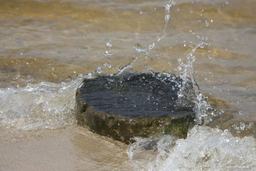 water splashes on rock