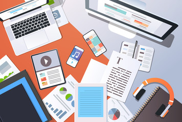 Wall Mural - digital content management information technology concept top angle view desktop computer tablet lap