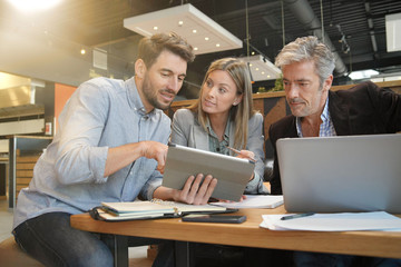 Casual sales team working through presentation with manager