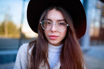 Wall Mural - Close-up portrait of beautiful caucasian woman with charming smile walking outdoors