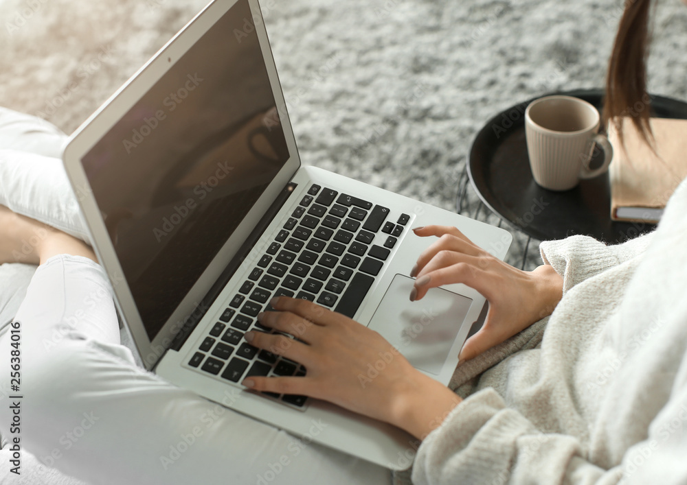 Beautiful young woman using laptop at home, closeup