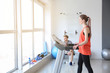 © Pixel-Shot - Sporty young woman training on treadmill in gym