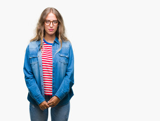 Poster - Beautiful young blonde woman wearing glasses over isolated background with serious expression on face. Simple and natural looking at the camera.