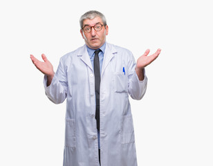 Sticker - Handsome senior doctor, scientist professional man wearing white coat over isolated background clueless and confused expression with arms and hands raised. Doubt concept.