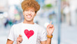 © Krakenimages.com - Young handsome man holding paper with red heart very happy pointing with hand and finger to the side