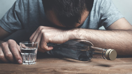 Caucasian alcoholic man with vodka.