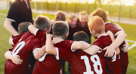 Kids Sport Team Huddle. Boys of Soccer Team Gathered Before the Tournament Final Match. Coach and Young Football Players Huddling