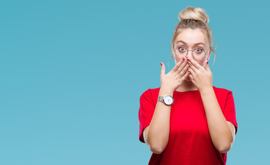 Poster - Young blonde woman wearing glasses over isolated background shocked covering mouth with hands for mistake. Secret concept.