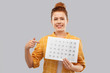 © Syda Productions - people concept - smiling red haired teenage girl in checkered shirt with calendar sheet over grey background