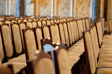 Empty places for orchestra on stage. The chairs are illuminated with yellow and blue light floodlights.