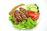 Fototapeta Las - fried sausages and salad on a white plate