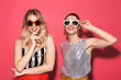 Photo of two posh women 20s in trendy outfit and sunglasses smiling at camera