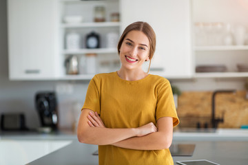 Young woman standing in the kitchen