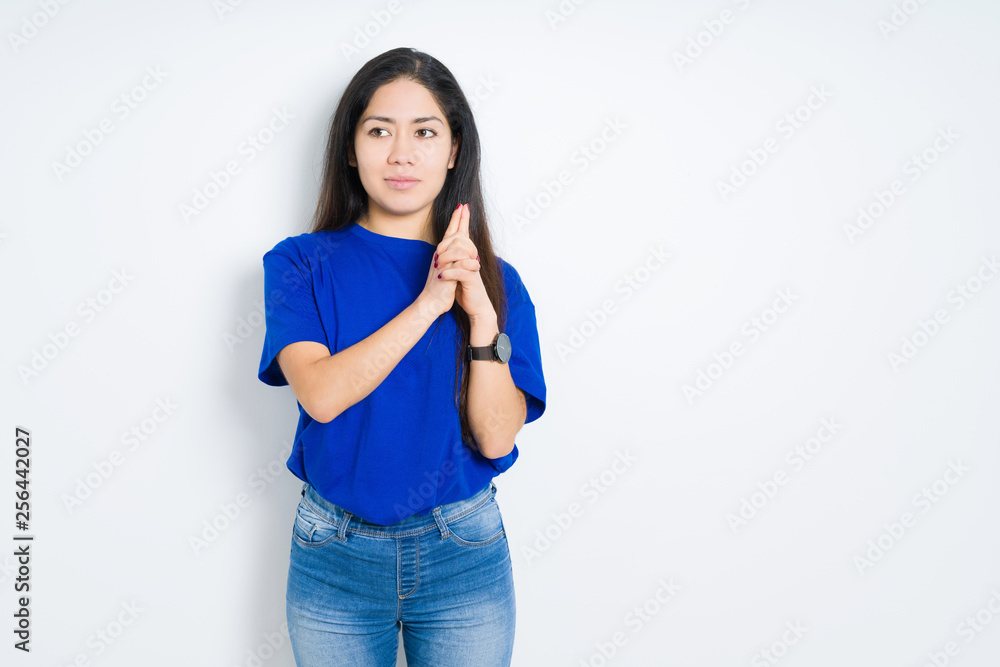 Beautiful brunette woman over isolated background Holding symbolic gun with hand gesture, playing killing shooting weapons, angry face