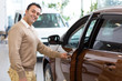 © Nestor - Hispanic mature man buying a new car