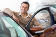 © Nestor - Hispanic mature man buying a new car
