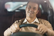 © Nestor - Handsome mature man sitting in his new car