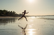 © Михаил Решетников - Woman runs barefoot on the beach at sunset. Silhouette of a woman by the sea at sunrise